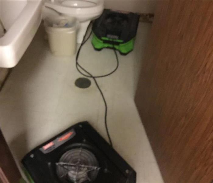 Drying equipment on floor in bathroom.