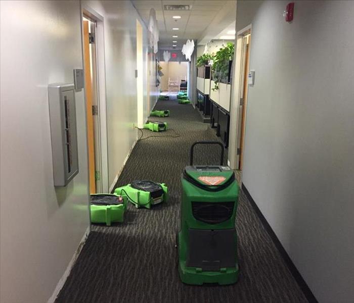 Our SERVPRO drying equipment set up along the hallway of an office space.