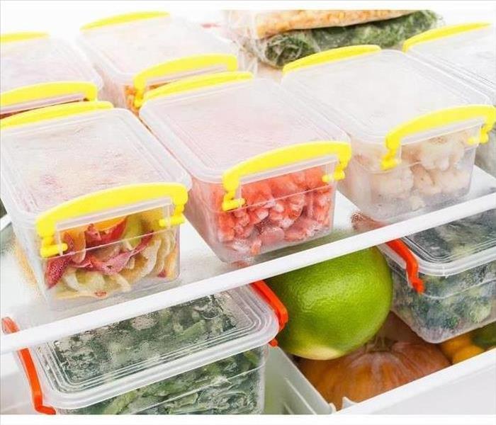 Plastic containers of food inside a refrigerator
